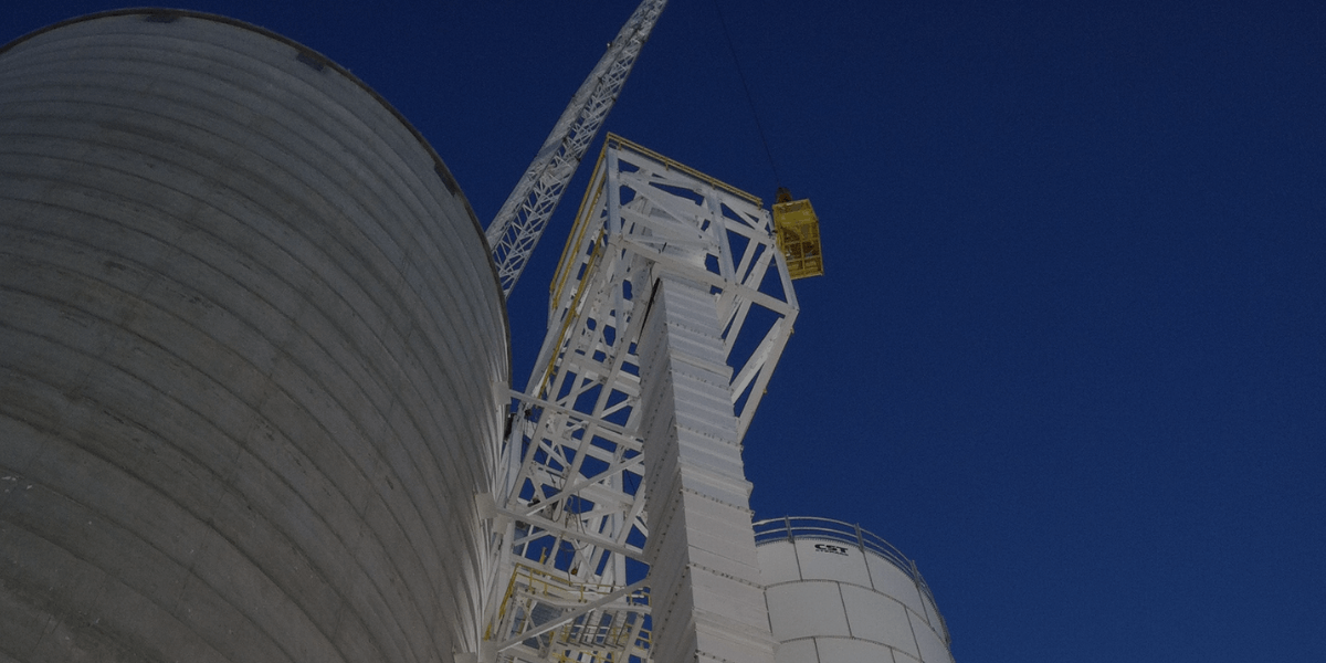Industrial silos and steel tower structure with crane support, showcasing Burkes Mechanical’s heavy fabrication and erection capabilities.
