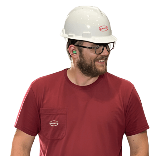 Burkes Mechanical employee in red shirt, glasses, and white hard hat with ear protection.