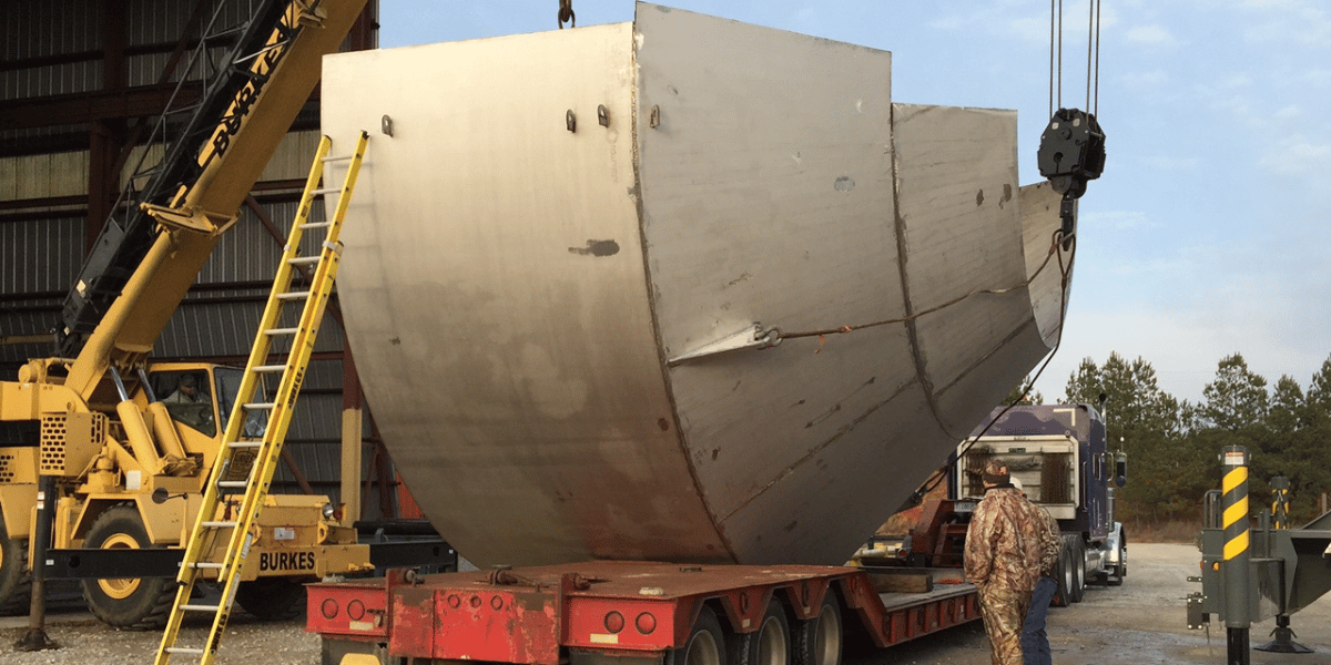 Burkes Fabrication Supervisor monitoring the delivery of a newly fabrication tank