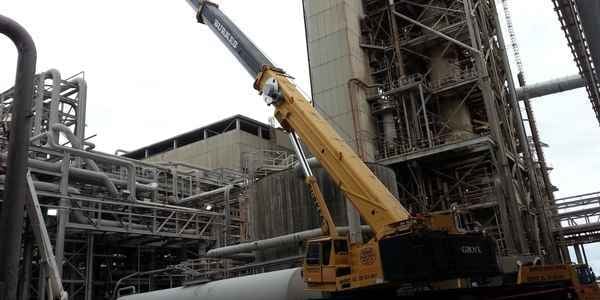 Burkes Mechanical industrial crane performing heavy equipment installation inside processing facility, supporting shutdowns, outages, and capital project execution