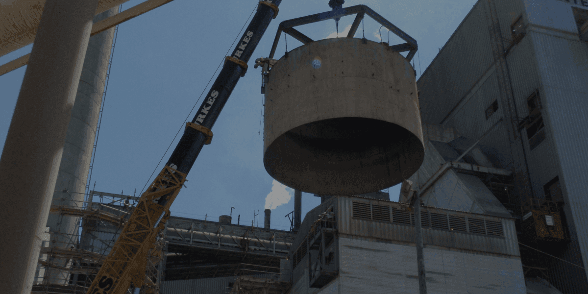 Crane lifting and setting large industrial vessel at manufacturing facility, supporting equipment installation, plant upgrades, and outage projects across the Southeast