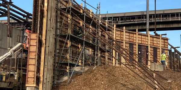 Burkes Civil Services crew installing scaffolding and large-scale concrete formwork at an industrial facility in the Southeast US, highlighting structural civil construction capabilities for pulp, paper, and wood products industries