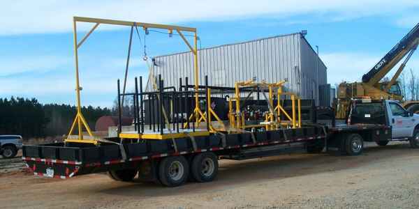 Burkes Mechanical fabricated pipe welding cart and structural steel assembly loaded on a flatbed trailer for transport to an automotive industrial job site, highlighting custom fabrication and mechanical services in the Southeast US